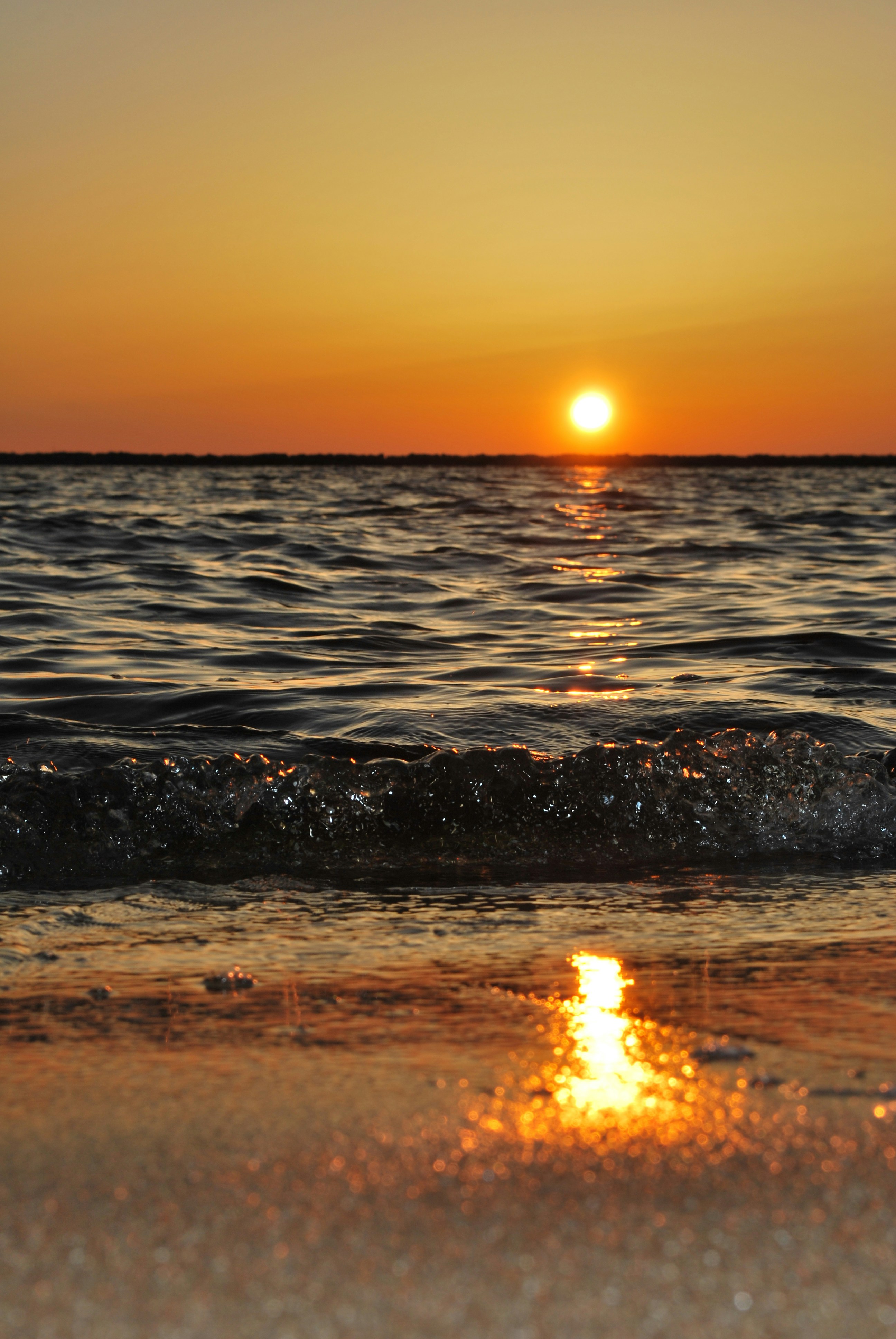 Golden sunset over ocean waves in Zanzibar
